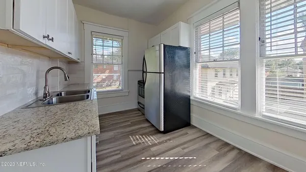a kitchen with a refrigerator and a sink