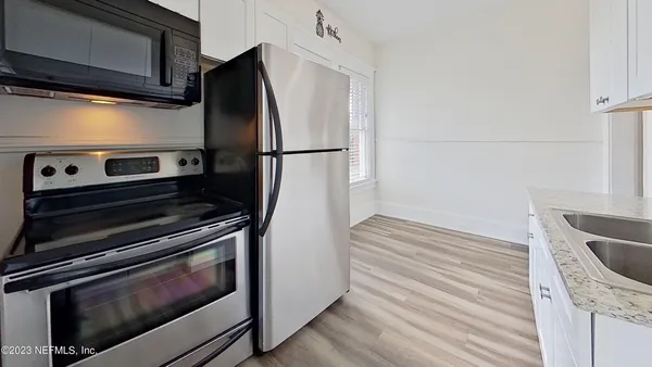 a kitchen with wooden cabinets and stainless steel appliances