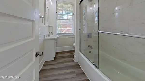 a bathroom with a bathtub and a shower