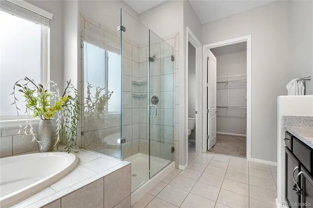 a bathroom with a granite countertop bathtub sink and mirror