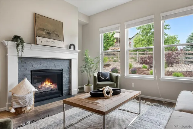 a living room with furniture fireplace and window