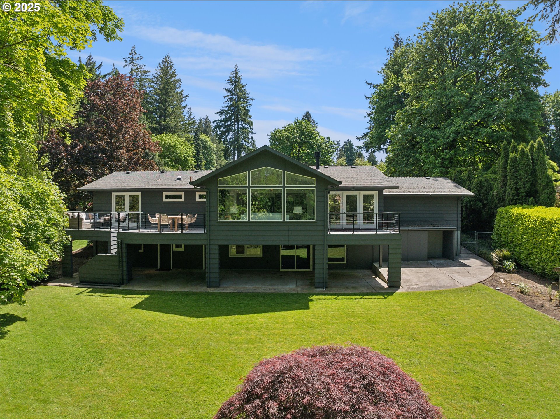 0501 South Riverside Street Portland, OR 97219 - Photo 39 of 45 a front view of a house with a yard table and chairs