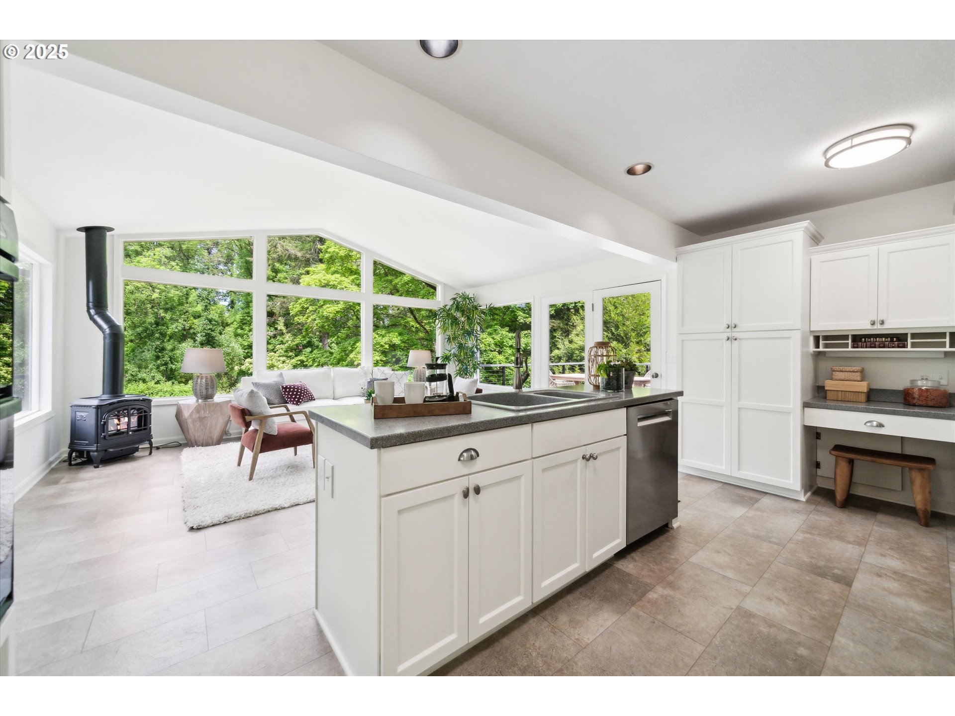 0501 South Riverside Street Portland, OR 97219 - Photo 6 of 45 a kitchen with stainless steel appliances kitchen island a large window in it