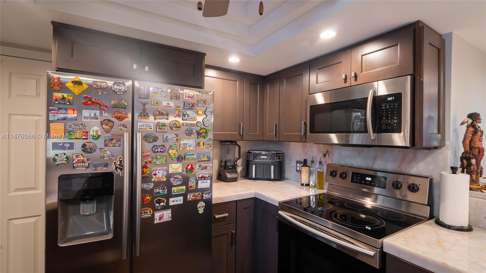 6500 Northwest 2nd Avenue, Unit 114 Boca Raton, FL 33487 - Photo 12 of 71 a kitchen with stainless steel appliances granite countertop a stove and a refrigerator