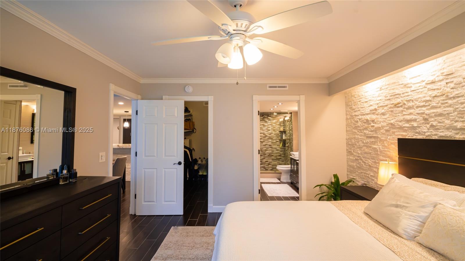 6500 Northwest 2nd Avenue, Unit 114 Boca Raton, FL 33487 - Photo 28 of 71 a bedroom with a bed and a chandelier