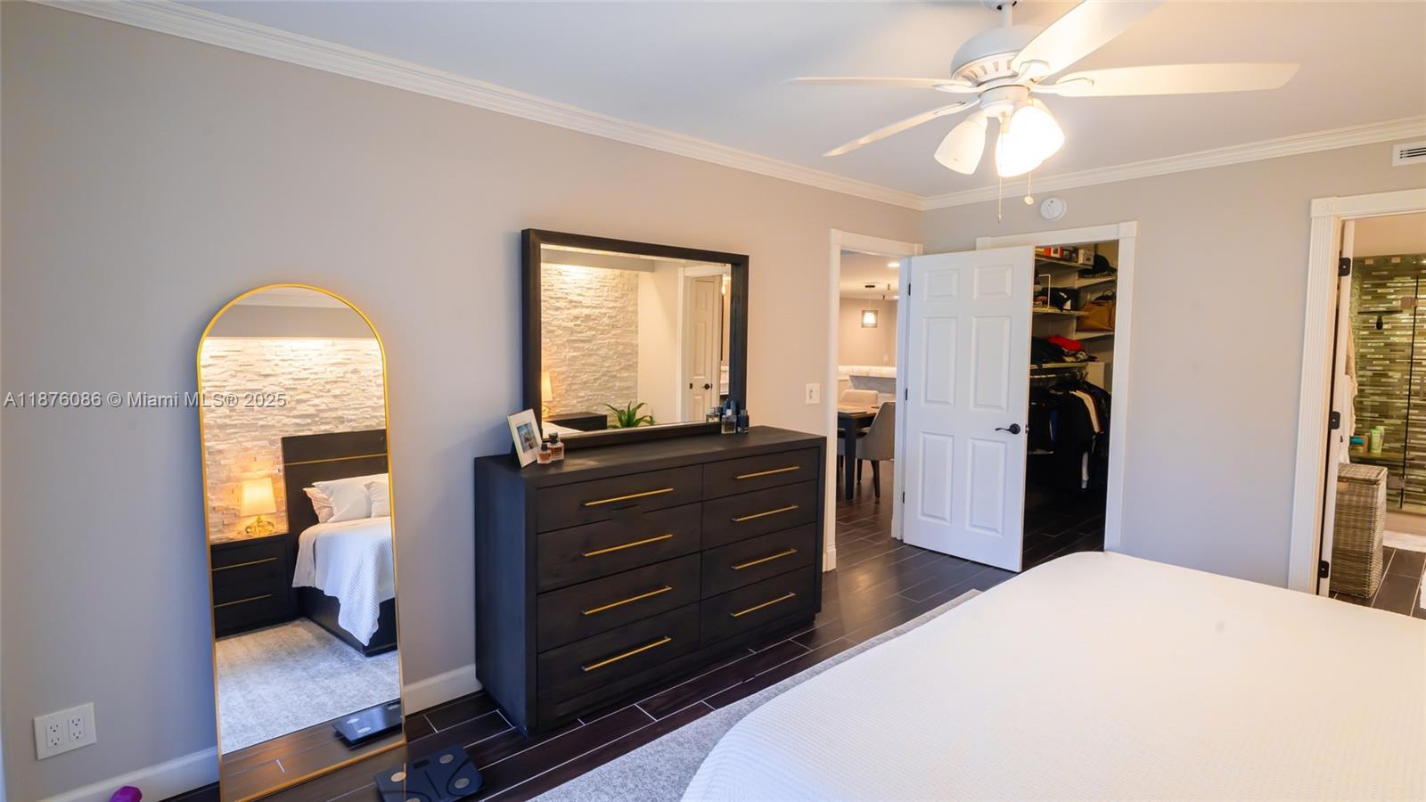 6500 Northwest 2nd Avenue, Unit 114 Boca Raton, FL 33487 - Photo 29 of 71 a room with a bed and a mirror