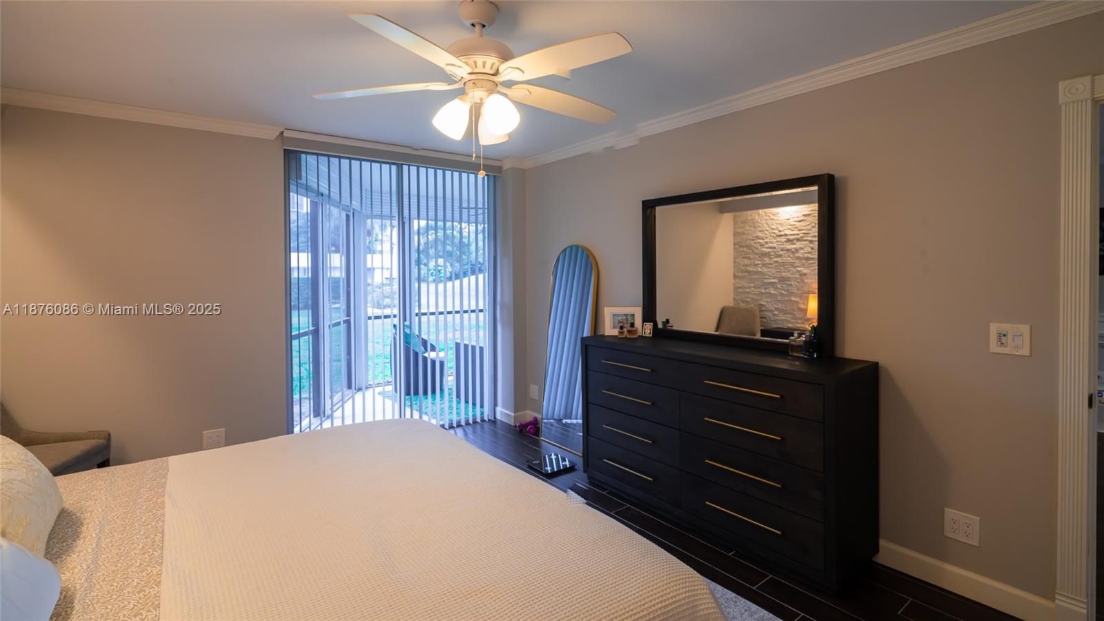 6500 Northwest 2nd Avenue, Unit 114 Boca Raton, FL 33487 - Photo 31 of 71 a bedroom with a bed and a mirror on dresser