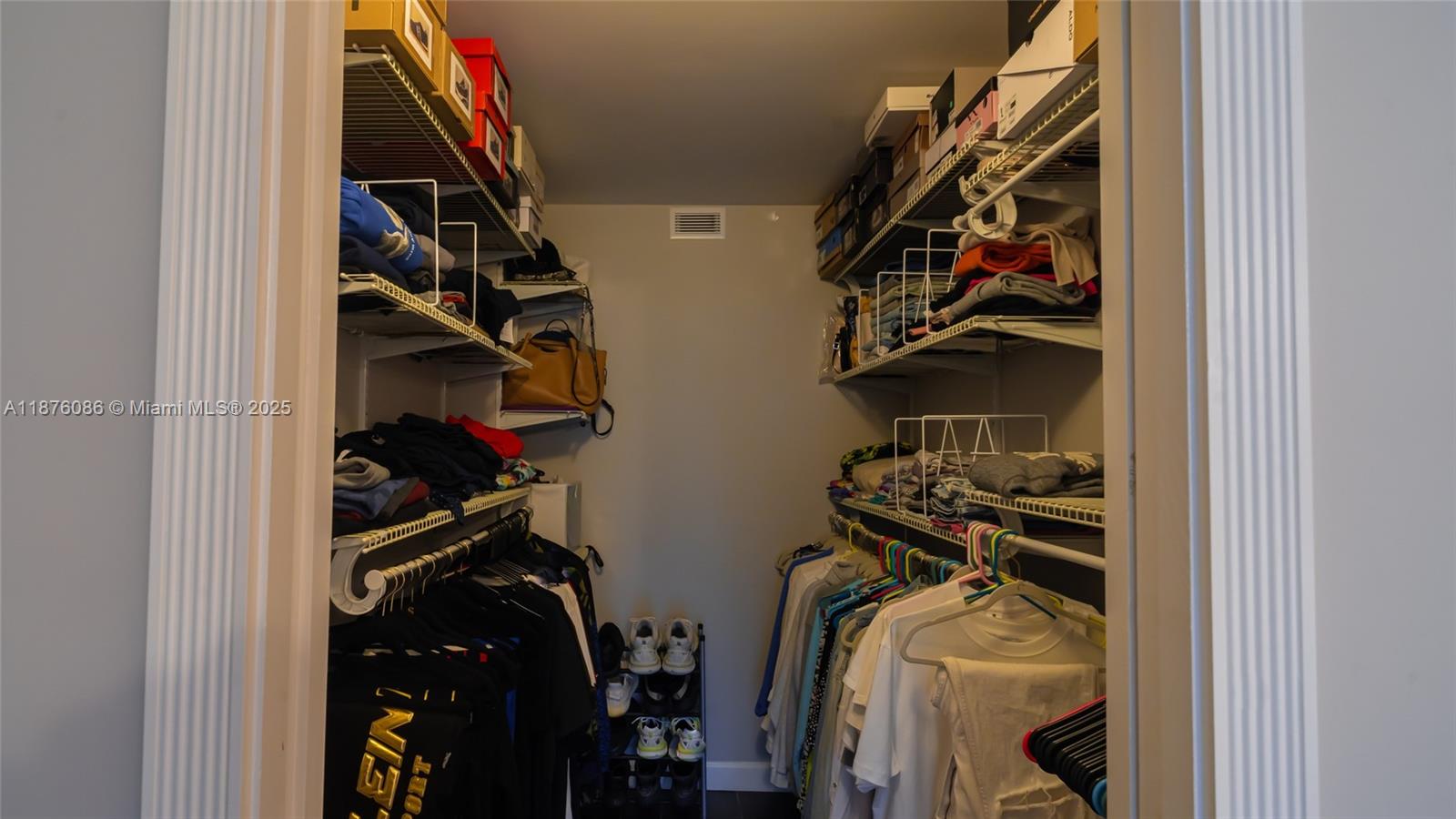 6500 Northwest 2nd Avenue, Unit 114 Boca Raton, FL 33487 - Photo 32 of 71 a view of walk in closet with clothes and shoes