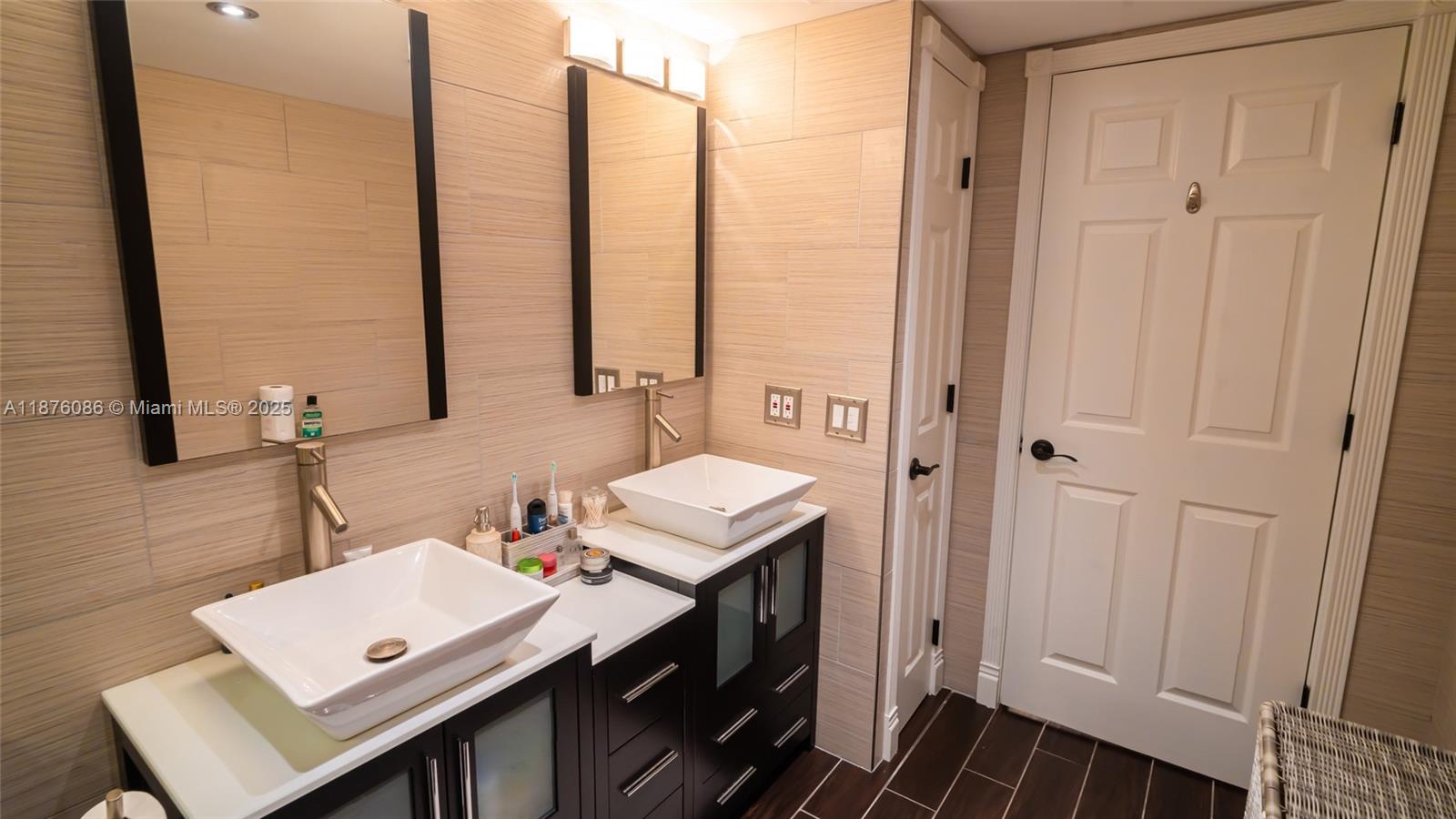 6500 Northwest 2nd Avenue, Unit 114 Boca Raton, FL 33487 - Photo 35 of 71 a bathroom with a sink a toilet and a mirror