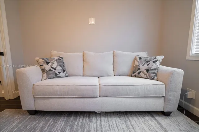 a view of a bathroom with a sink and wooden floor