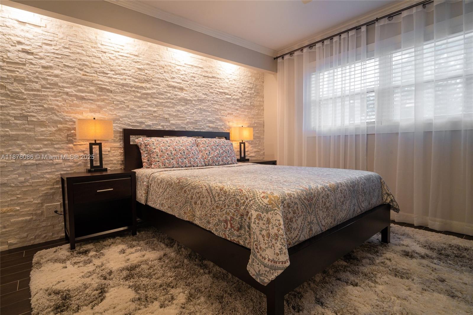 6500 Northwest 2nd Avenue, Unit 114 Boca Raton, FL 33487 - Photo 51 of 71 a bedroom with a bed and a window