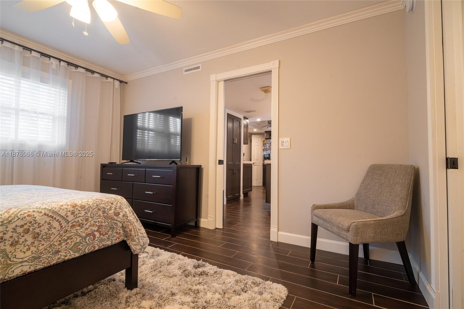 6500 Northwest 2nd Avenue, Unit 114 Boca Raton, FL 33487 - Photo 52 of 71 a bedroom with a bed and wooden floor