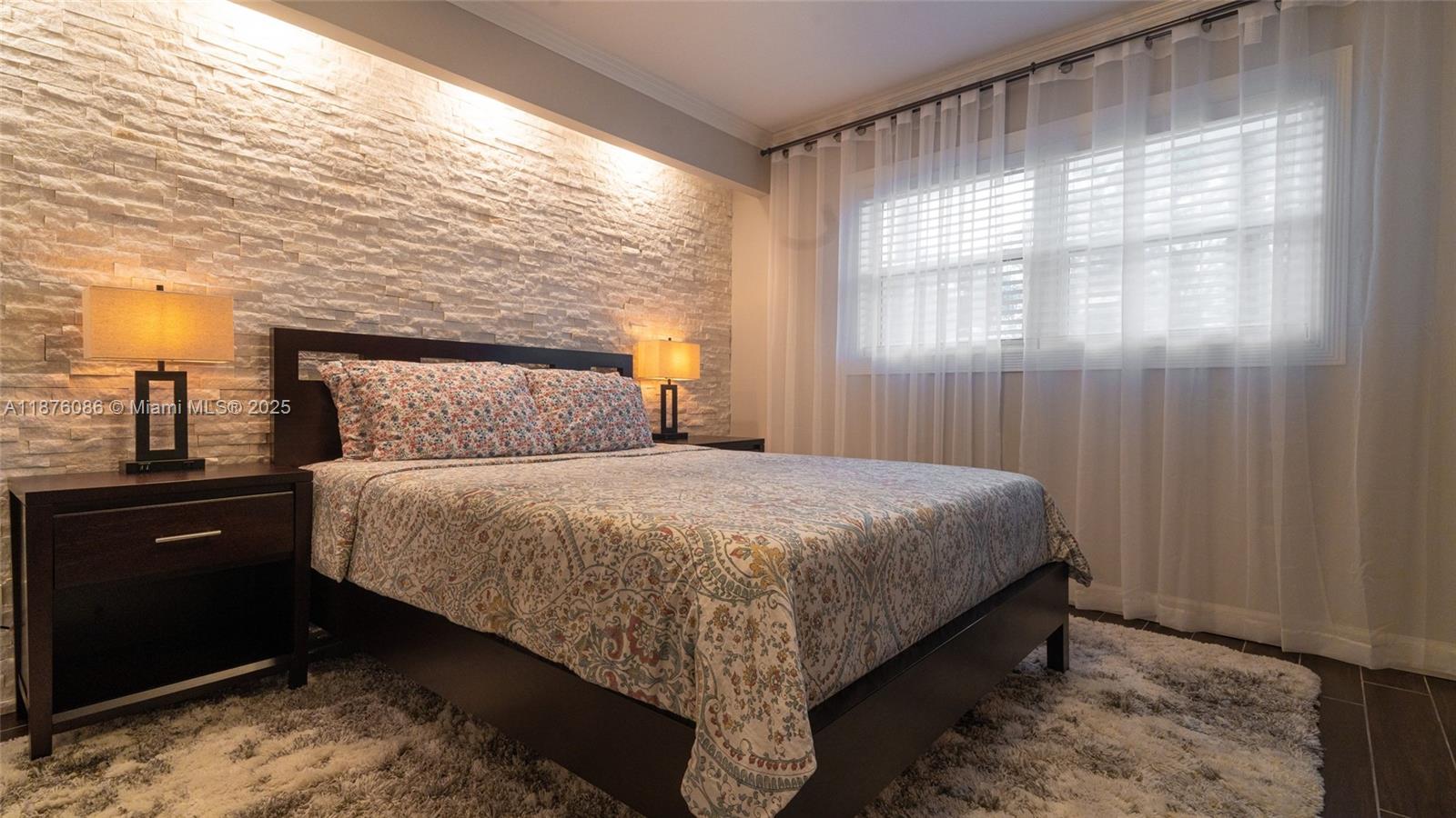 6500 Northwest 2nd Avenue, Unit 114 Boca Raton, FL 33487 - Photo 53 of 71 a bedroom with a bed and window