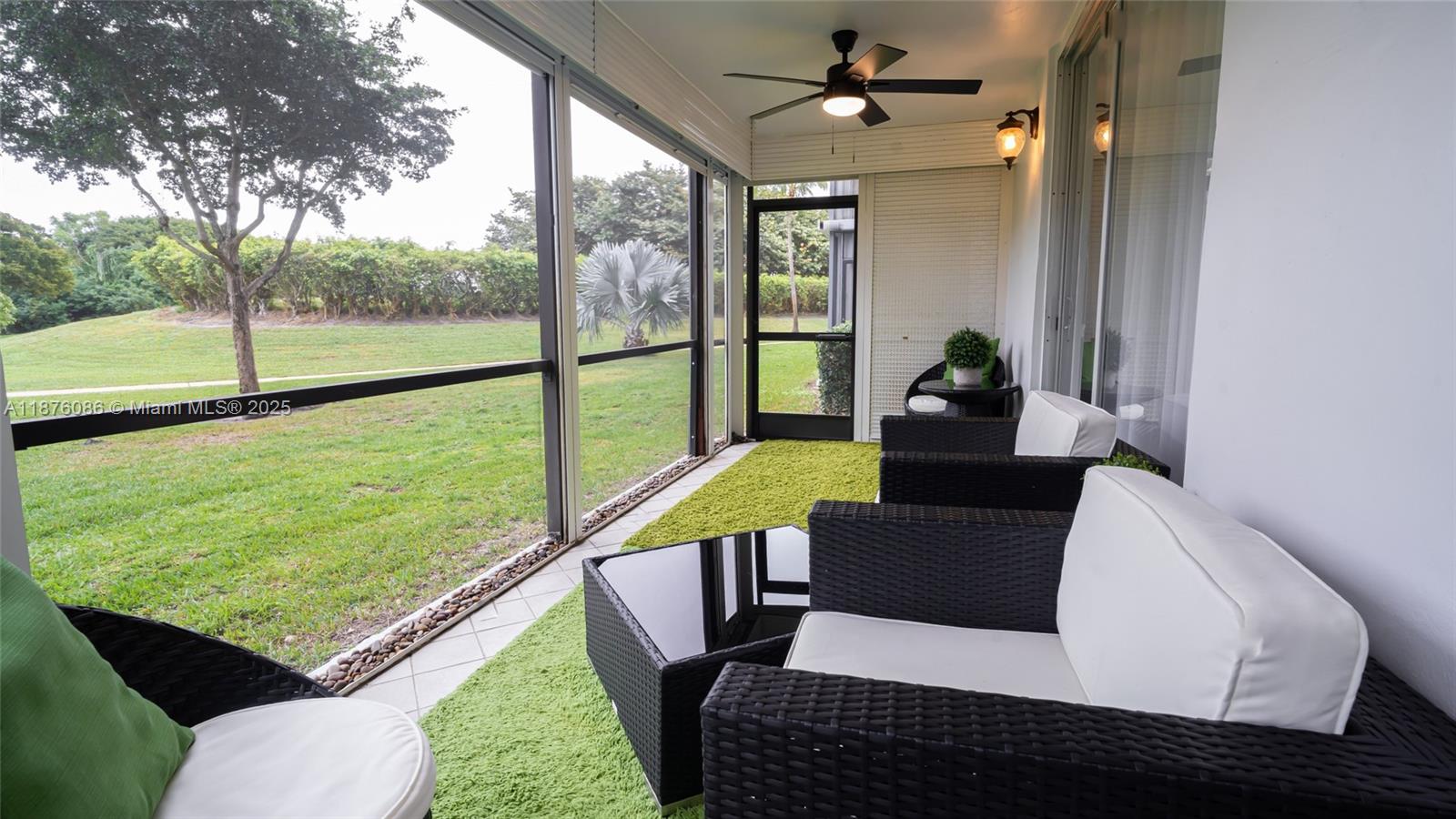 6500 Northwest 2nd Avenue, Unit 114 Boca Raton, FL 33487 - Photo 59 of 71 a living room with furniture and a floor to ceiling window