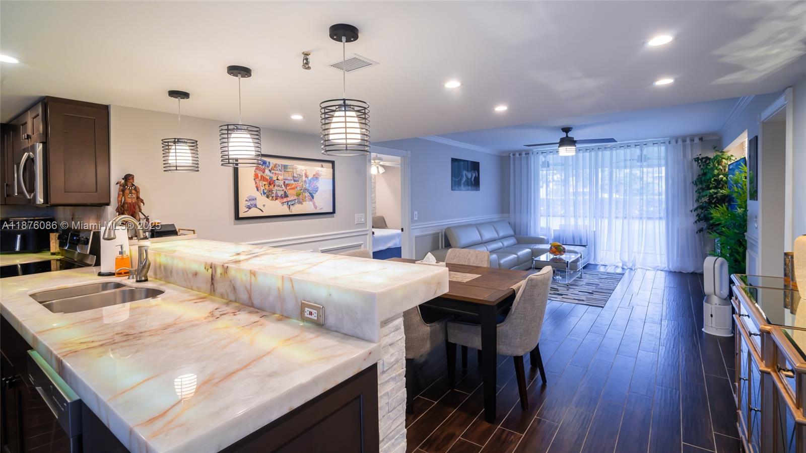 6500 Northwest 2nd Avenue, Unit 114 Boca Raton, FL 33487 - Photo 7 of 71 a view of a dining room with furniture and wooden floor