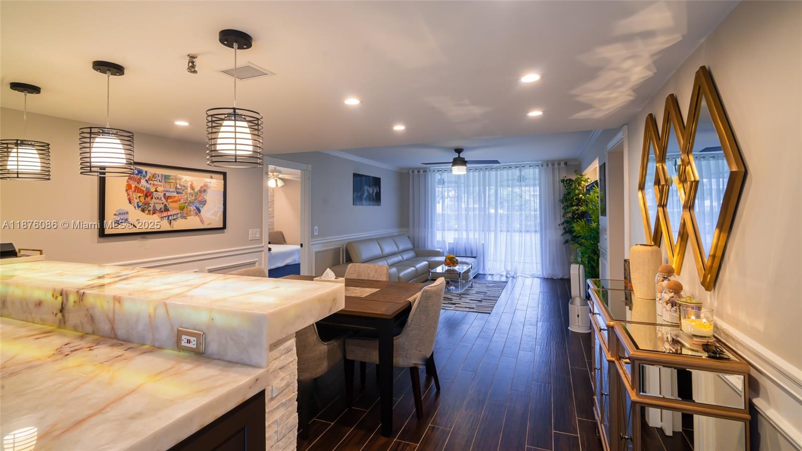 6500 Northwest 2nd Avenue, Unit 114 Boca Raton, FL 33487 - Photo 8 of 71 a view of a dining room with furniture window and wooden floor