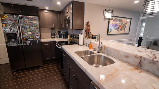 a kitchen with stainless steel appliances granite countertop a stove and a refrigerator