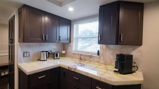 a view of kitchen with stainless steel appliances kitchen island a refrigerator sink and stove