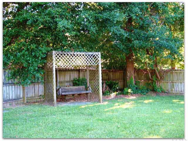717 Valley Grande Road Pensacola, FL 32514 - Photo 23 of 24 Swing in your backyard underneath the trees.