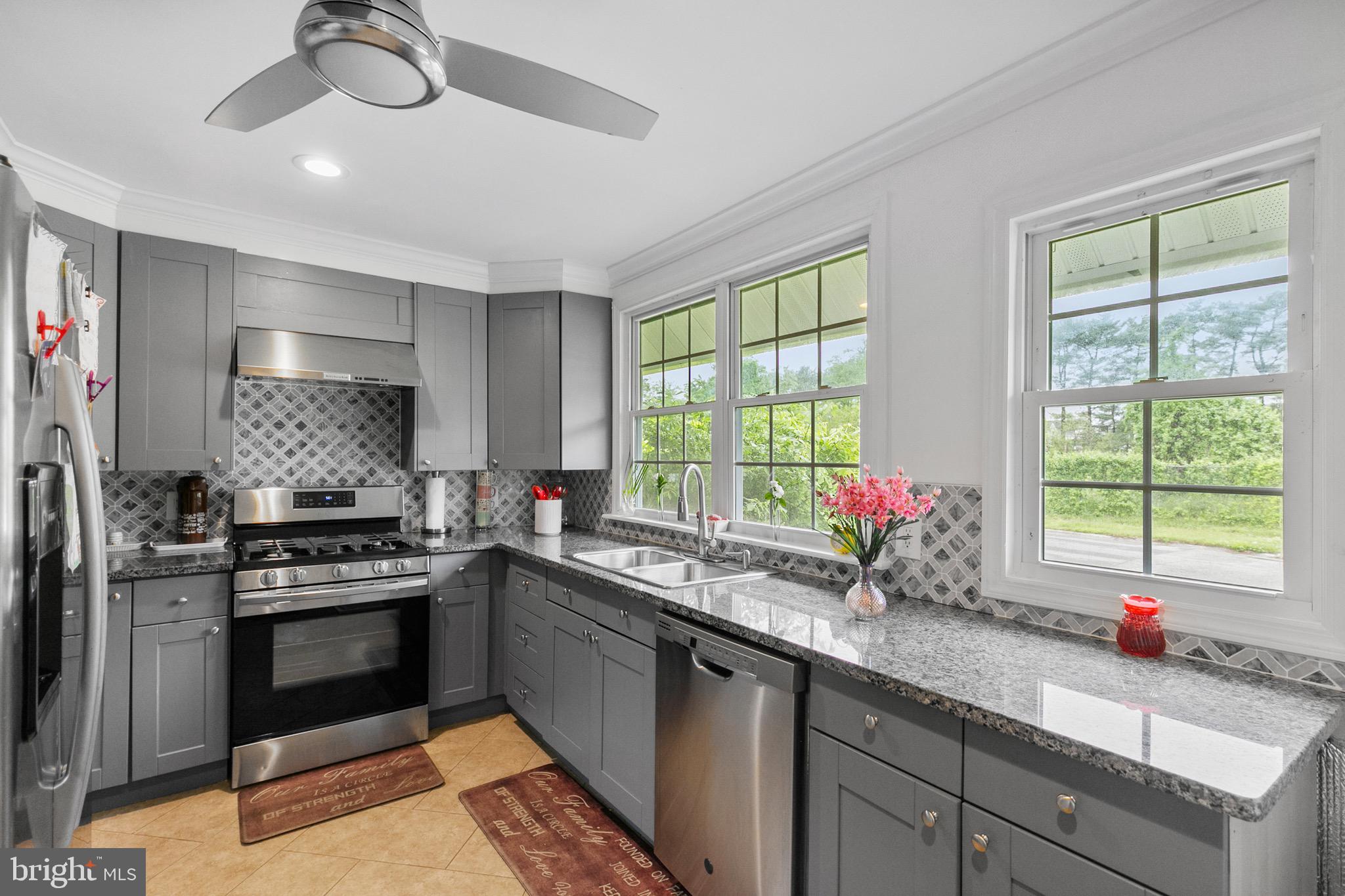 68 Shawmont Lane Willingboro, NJ 08046 - Photo 10 of 25 a kitchen with a stove a sink and a window