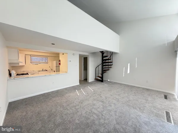 a kitchen with granite countertop white cabinets and white stainless steel appliances