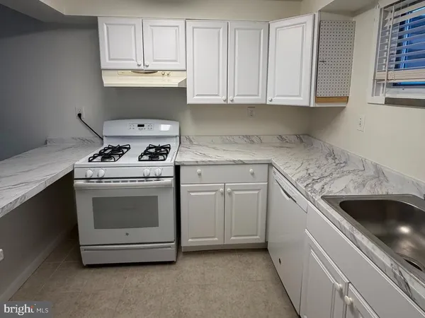 a kitchen with a sink stove and refrigerator