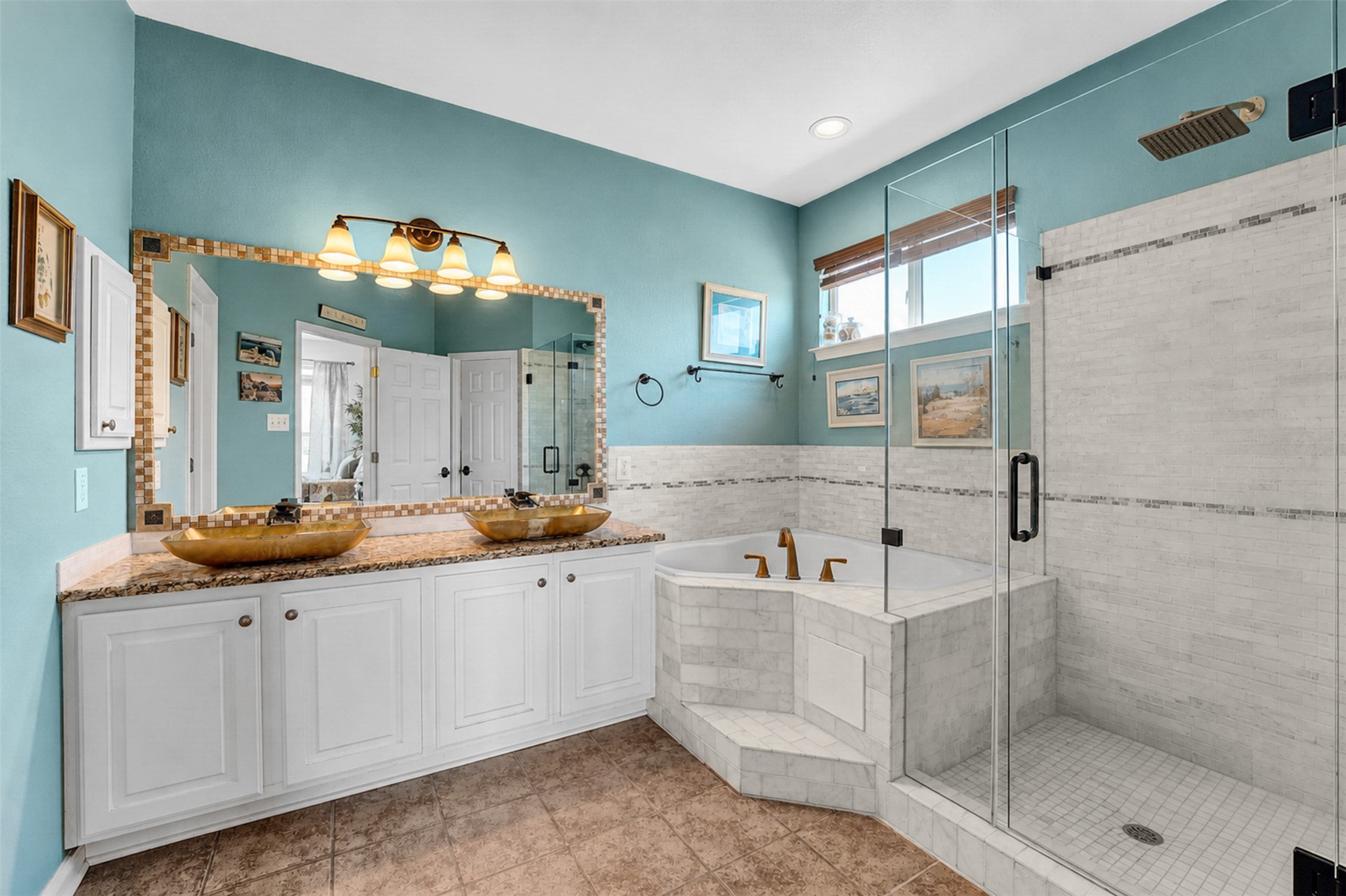 2521 Amen Corner Road Pflugerville, TX 78660 - Photo 21 of 40 Dual vessel sinks with bronze-finish fixtures set atop a stone-finish countertop with ample white cabinetry