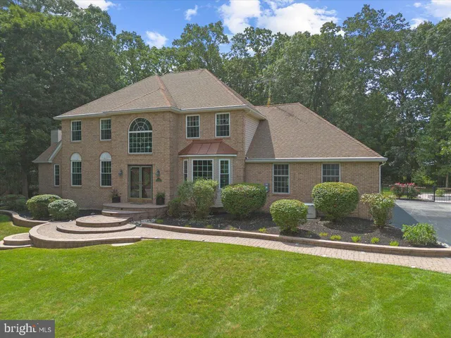 a aerial view of a house with a yard table and chairs