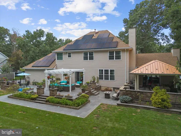 a view of a house with backyard and sitting area