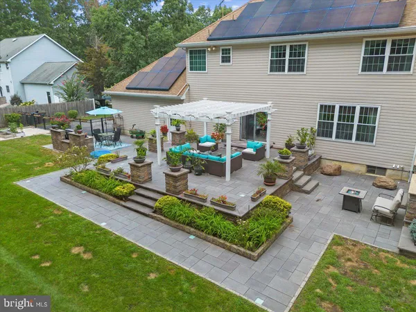 a view of a patio with couches table and chairs and potted plants