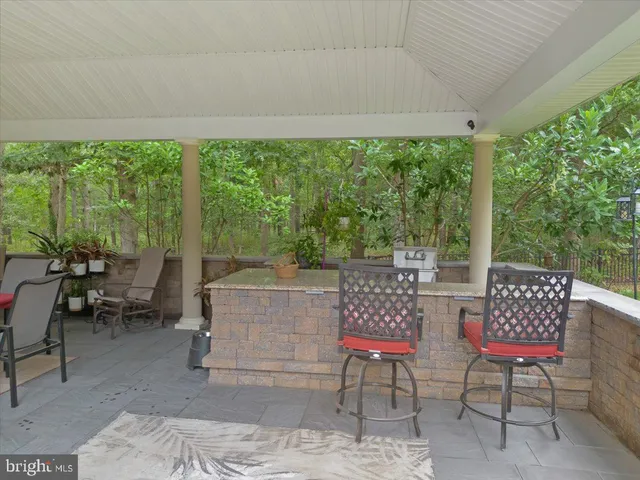 a view of a fountain in a yard with large trees