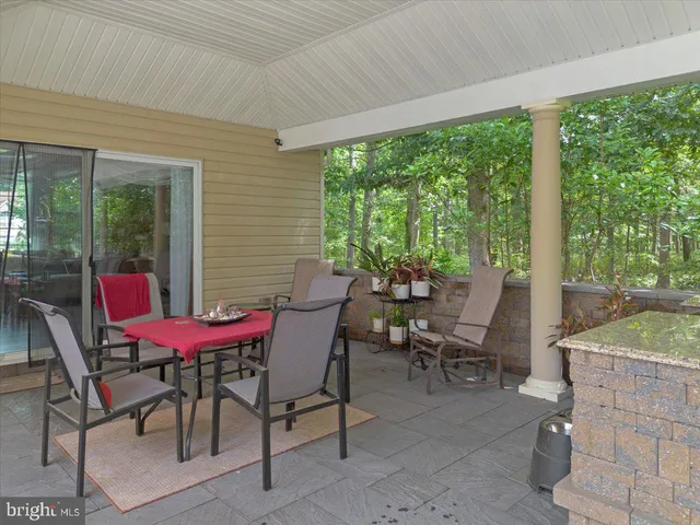 an aerial view of a house with a garden and trees