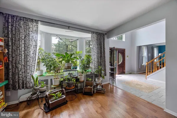 a living room with furniture a fireplace and a large window
