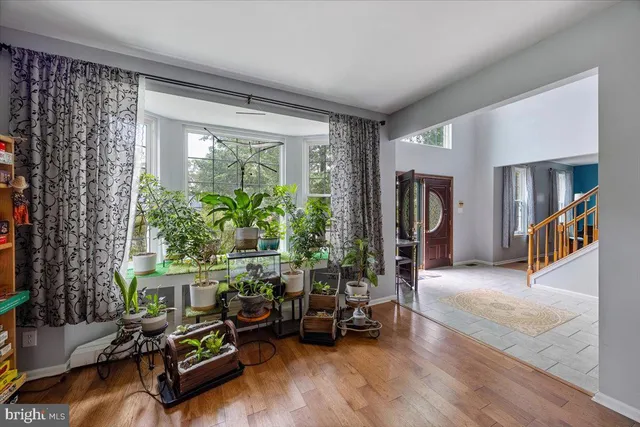 a living room with furniture a fireplace and a large window