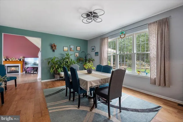 a kitchen with sink refrigerator dining table and chairs