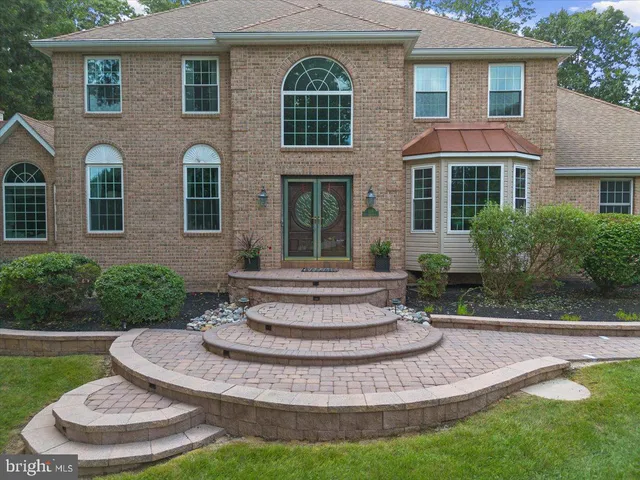 a view of a house with fountain in a yard