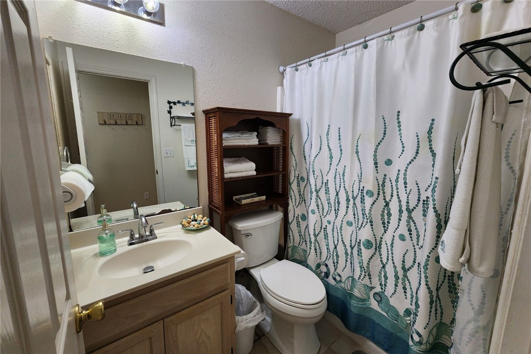 14721 Lighthouse Drive Corpus Christi, TX 78418 - Photo 12 of 17 a bathroom with a sink toilet and shower