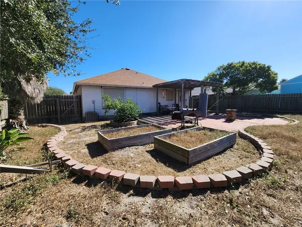 a view of a house with backyard couches and a fire pit