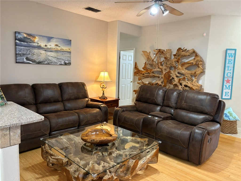 14721 Lighthouse Drive Corpus Christi, TX 78418 - Photo 2 of 17 a living room with furniture and a painting
