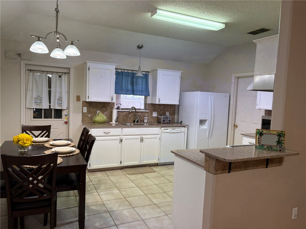 14721 Lighthouse Drive Corpus Christi, TX 78418 - Photo 4 of 17 a kitchen with a refrigerator and a stove top oven
