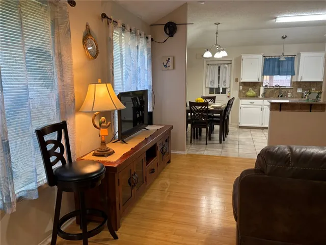 a living room with stainless steel appliances kitchen island granite countertop furniture and a kitchen view
