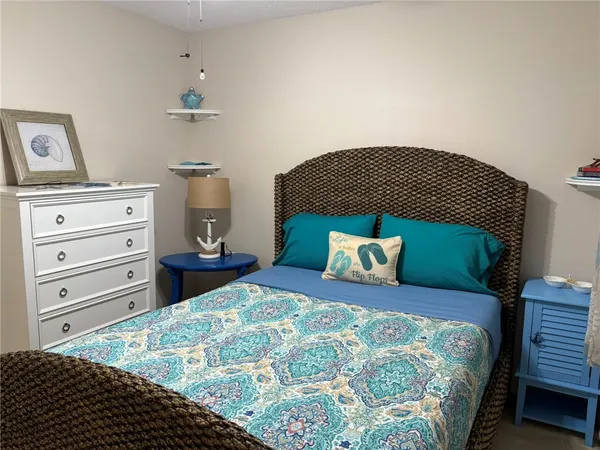 a bedroom with a bed and lamp