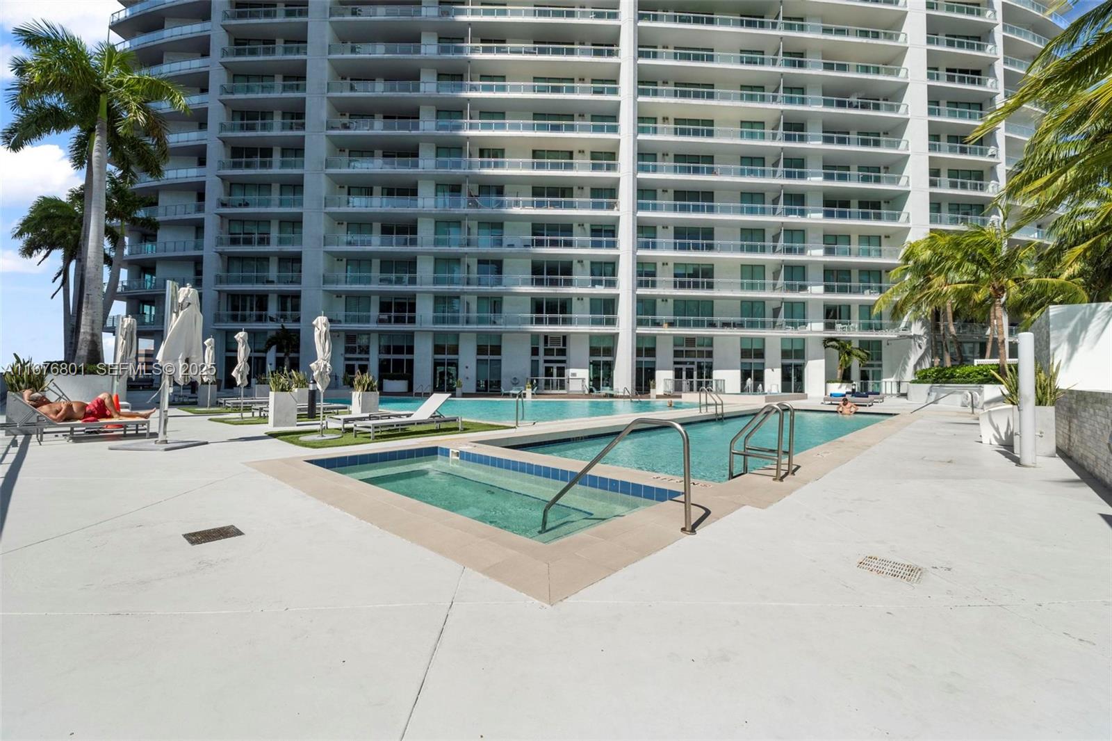 90 Southwest 3rd Street, Unit 1416 Miami, FL 33130 - Photo 28 of 31 a view of a swimming pool with a bench in front of house