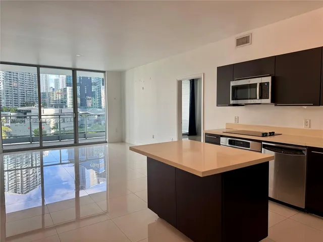 a kitchen that has a sink and a stove in it
