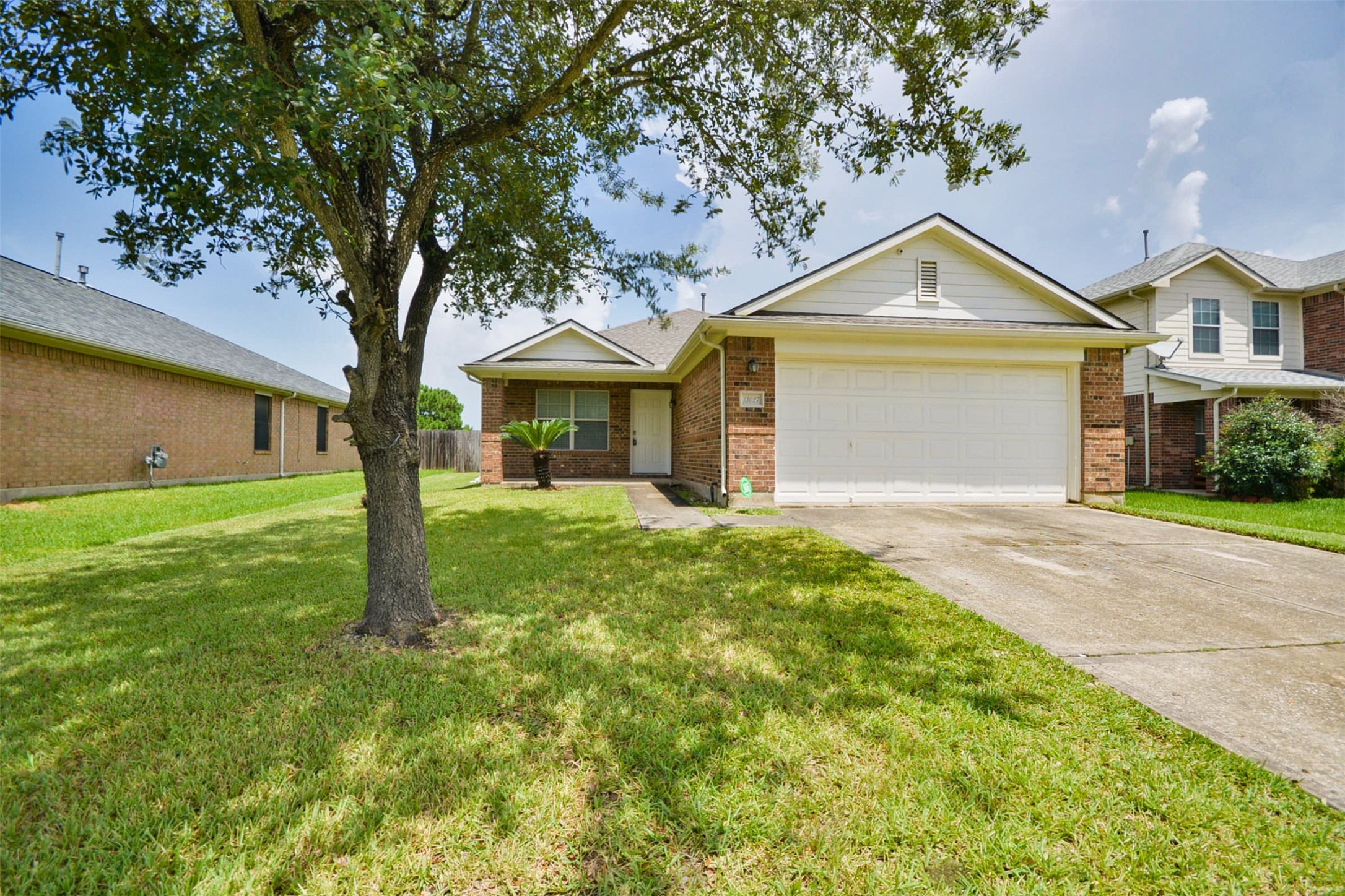 a front view of a house with yard and green space