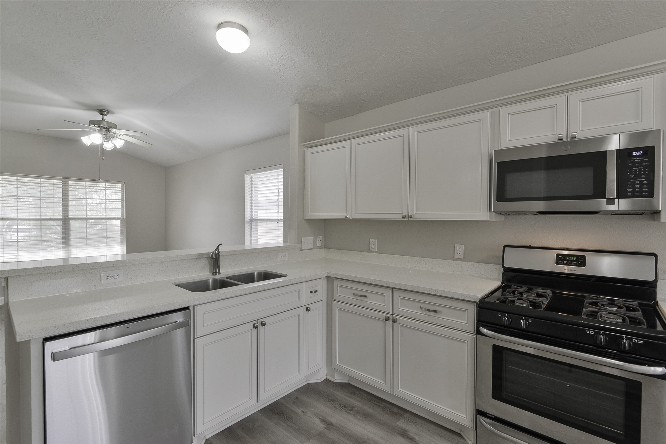 13027 Lark Point Court Houston, TX 77044 - Photo 11 of 29 a kitchen with a sink stove and microwave