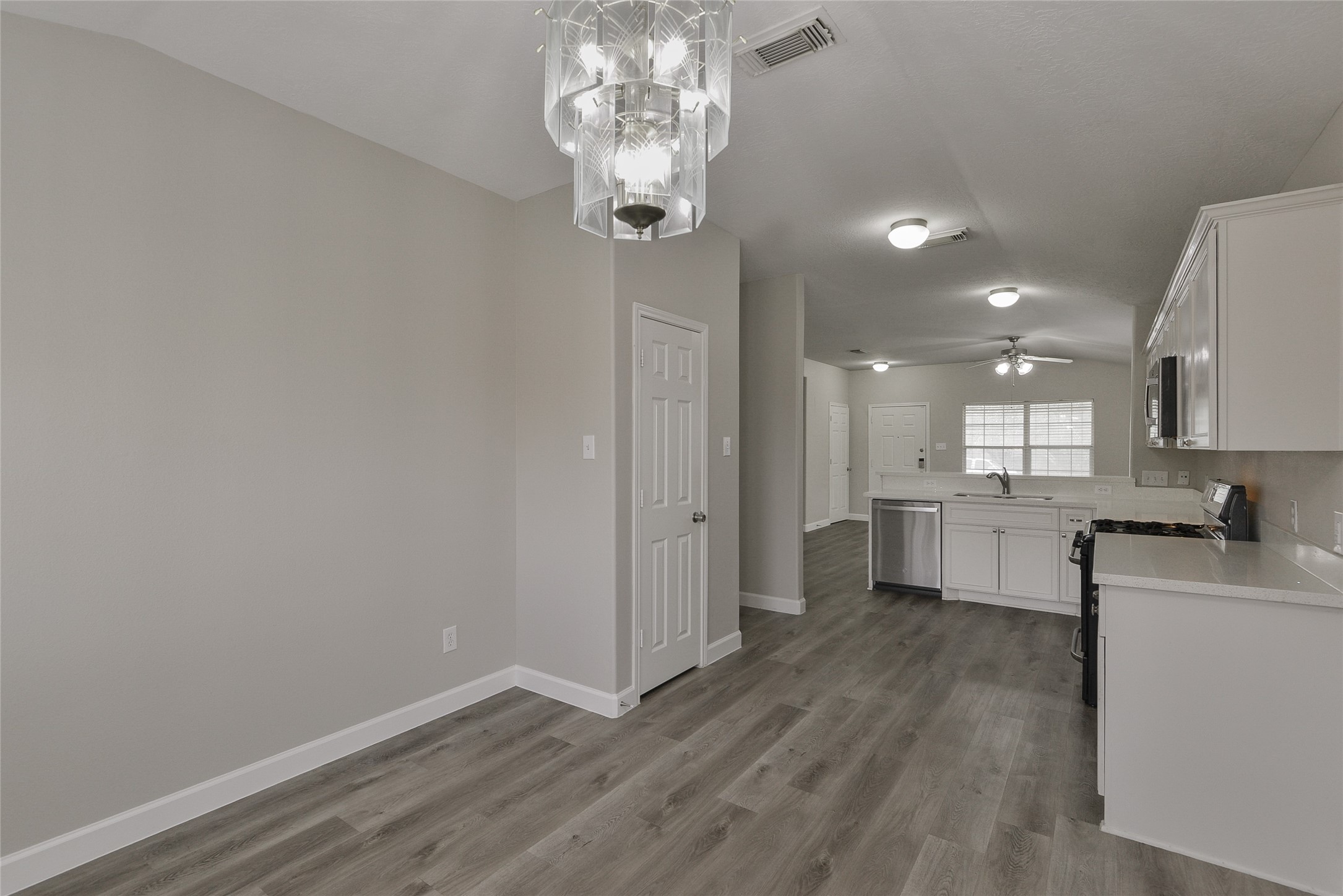 13027 Lark Point Court Houston, TX 77044 - Photo 14 of 29 a view of a kitchen with center island stainless steel appliances wooden floor and a window