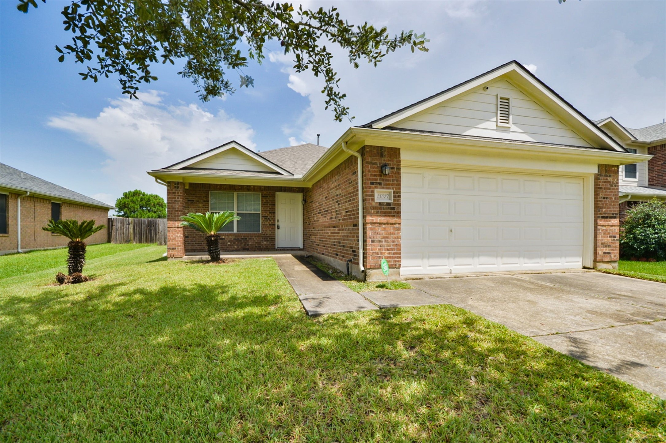 13027 Lark Point Court Houston, TX 77044 - Photo 2 of 29 a front view of a house with a yard and porch