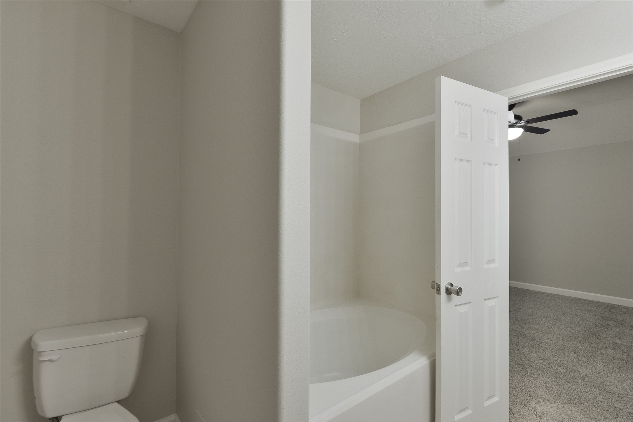 13027 Lark Point Court Houston, TX 77044 - Photo 27 of 29 a bathroom with a bathtub and a toilet