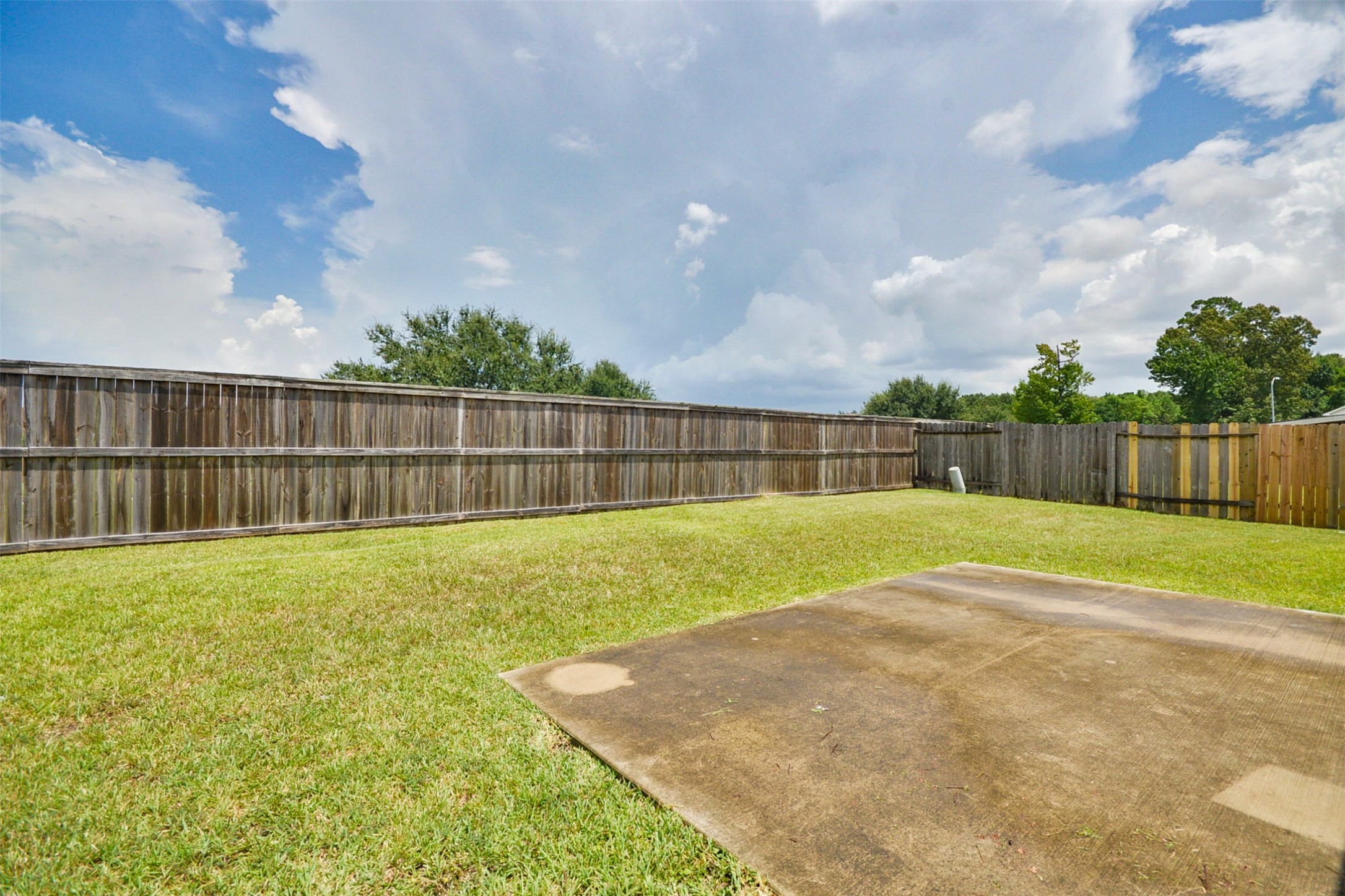 13027 Lark Point Court Houston, TX 77044 - Photo 29 of 29 a view of a backyard with grass and a fence